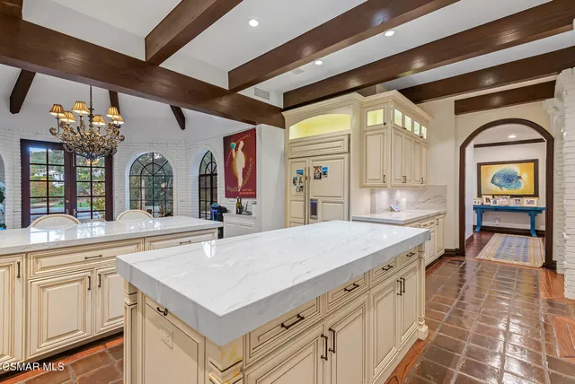 a bathroom with a sink a vanity and a large mirror