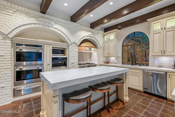 a large white kitchen with a large window