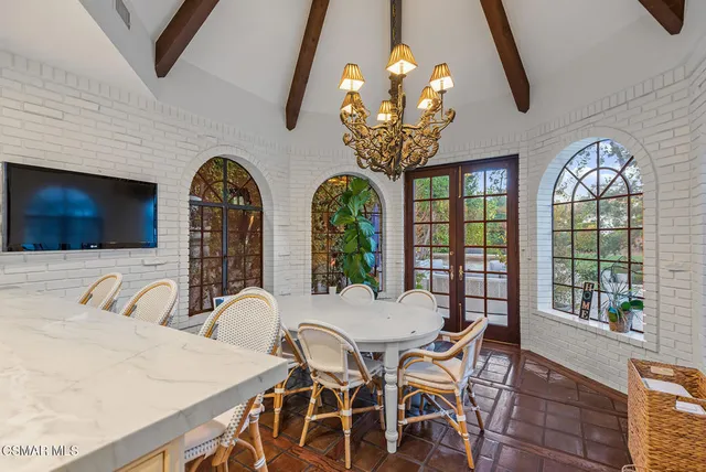 a view of a dining room with furniture wooden floor and chandelier