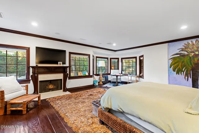 a bed room with a bed and a fireplace