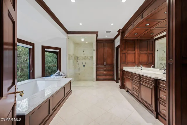 a large bathroom with a large tub and sink