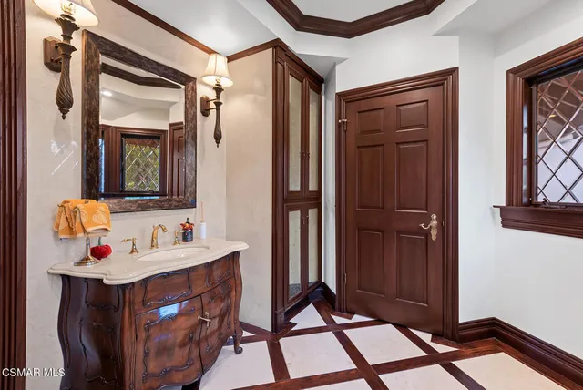 a bathroom with a sink mirror and vanity