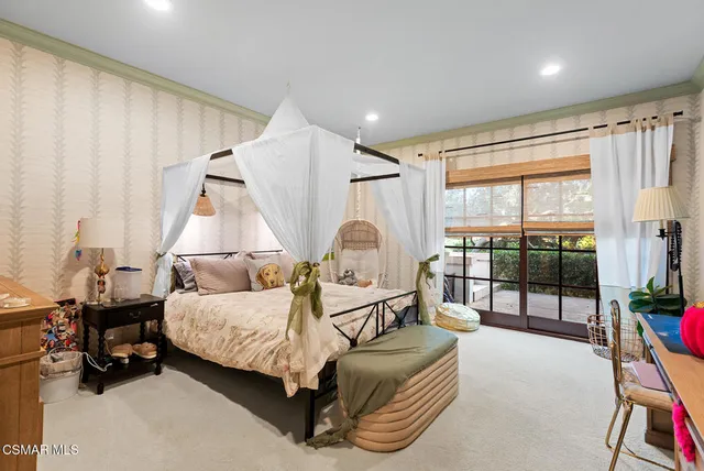 a bedroom with bed and glass door