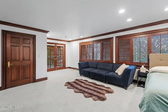 a living room with furniture and large window