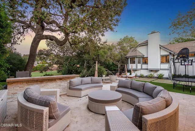 a view of patio with couches and a fire pit