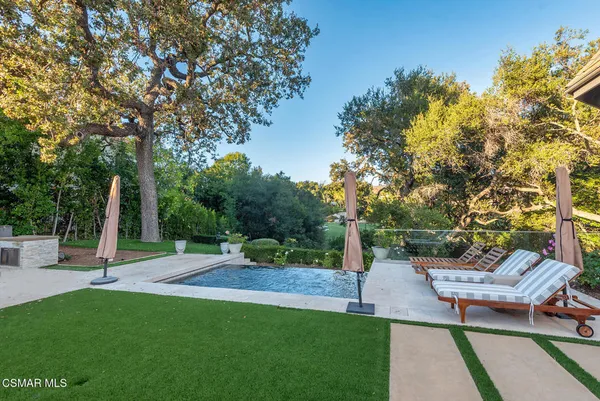 a view of a backyard with sitting area