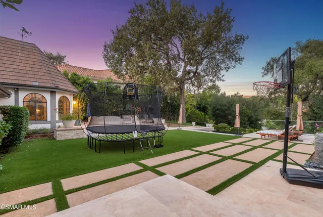 a view of a patio with a table and chairs