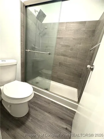 a view of a balcony with wooden floor and fence