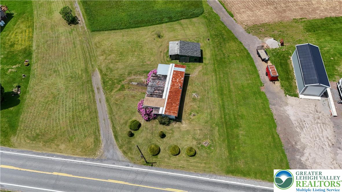 3551 Quakake Road Weatherly, PA 18255 - Photo 5 of 12 An aerial view captures a farm with multiple structures and ample open land, offering vast potential.