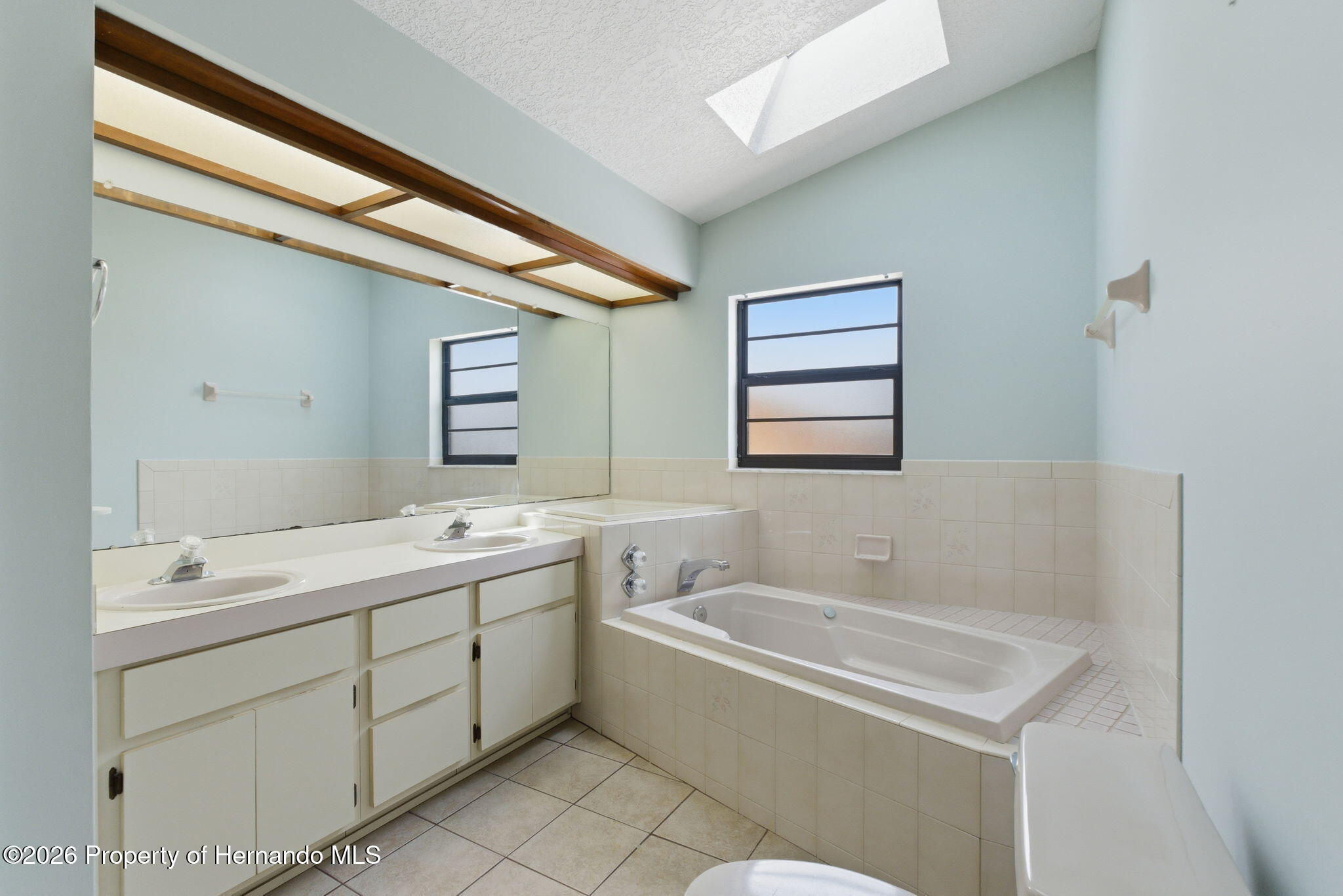 4966 Keysville Avenue Spring Hill, FL 34608 - Photo 28 of 50 a bathroom with a tub sink and mirror