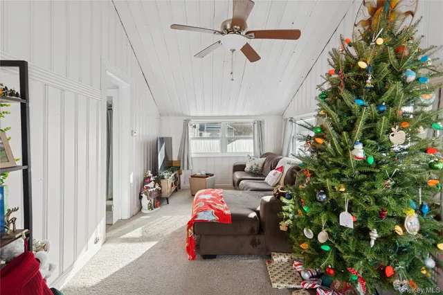 a bedroom with ceiling fan and window
