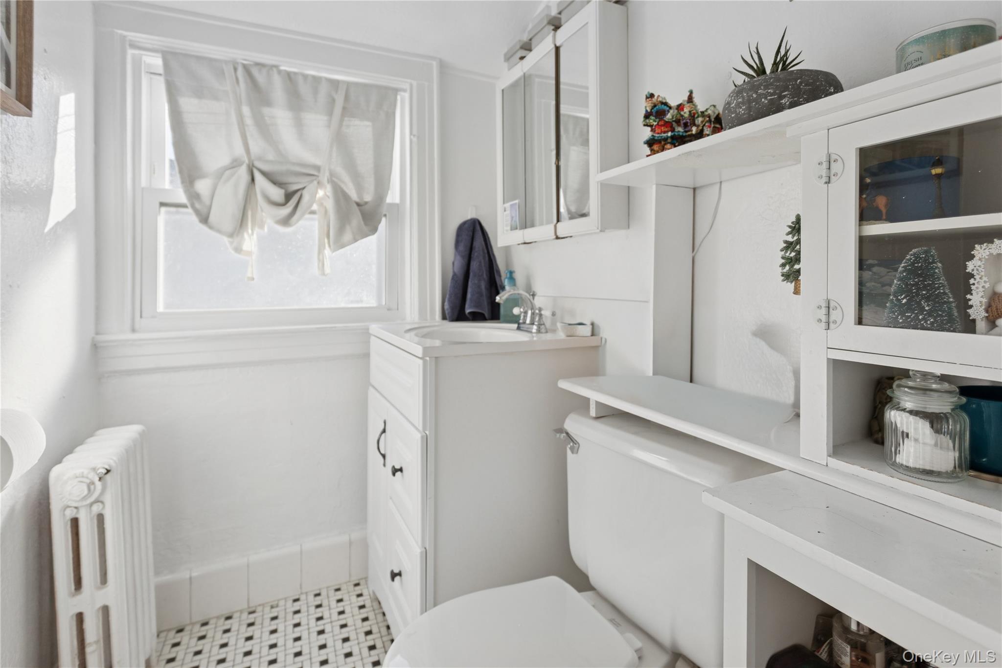 107 Pacific Boulevard Long Beach, NY 11561 - Photo 16 of 23 Bathroom featuring radiator, vanity, and light flooring