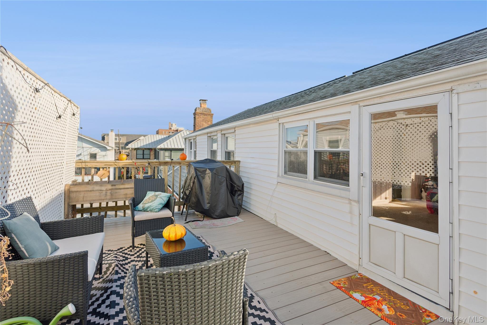 107 Pacific Boulevard Long Beach, NY 11561 - Photo 21 of 23 Wooden terrace with grilling area and an outdoor hangout area