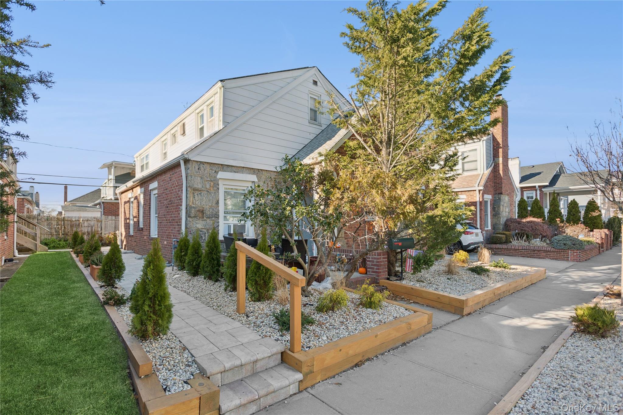 107 Pacific Boulevard Long Beach, NY 11561 - Photo 23 of 23 View of front of property featuring stone siding and brick siding
