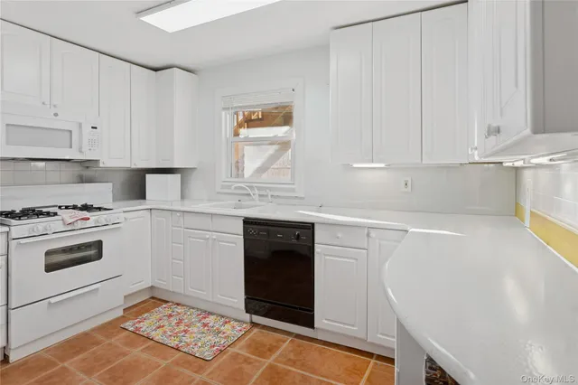 a kitchen with granite countertop cabinets stainless steel appliances and a counter space