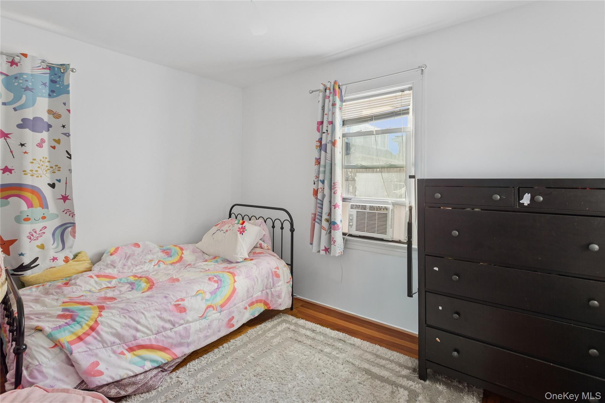 107 Pacific Boulevard Long Beach, NY 11561 - Photo 9 of 23 Bedroom with wood finished floors and cooling unit