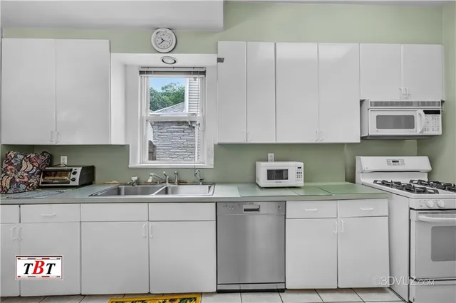 a kitchen with stainless steel appliances granite countertop a sink stove and cabinets
