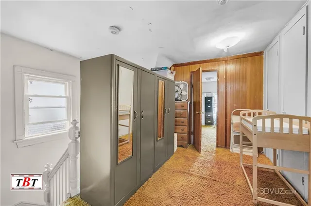 a living room with furniture and a book shelf