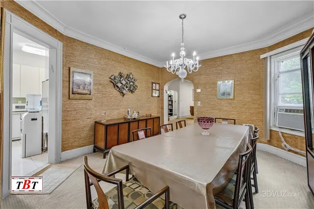 a view of a dining room with furniture and chandelier