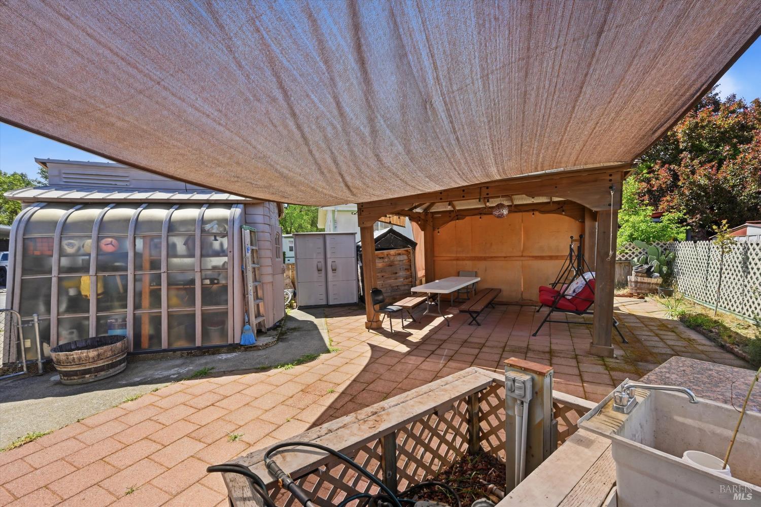 4801 North State Street, Unit 10 Ukiah, CA 95482 - Photo 20 of 23 Shade cloth and gazebo do not convey; shed with pop-out shown at left is included with sale.
