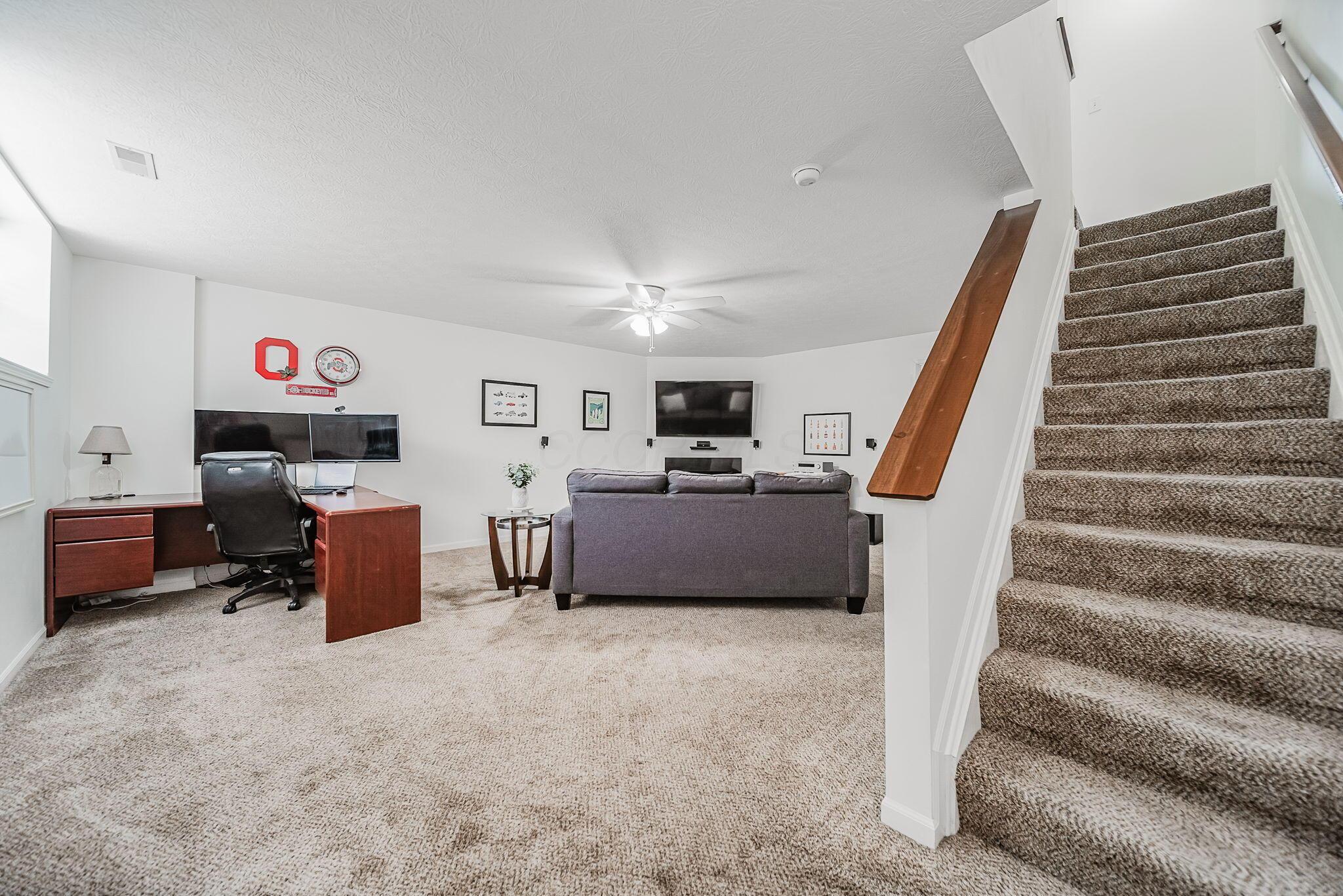 6186 Needletail Road, Unit 66 Columbus, OH 43230 - Photo 23 of 48 Finished lower level with daylight window, neutral decor, overhead lighting, and a cozy gas fireplace make this a beautiful area to spend quality time in for work and play!