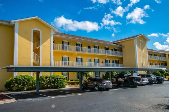 a view of a blue and white car parked in front of a building