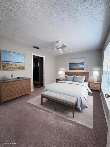 a spacious bedroom with a bed and a night stand