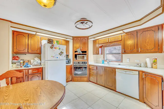 a kitchen with stainless steel appliances granite countertop a refrigerator and a stove