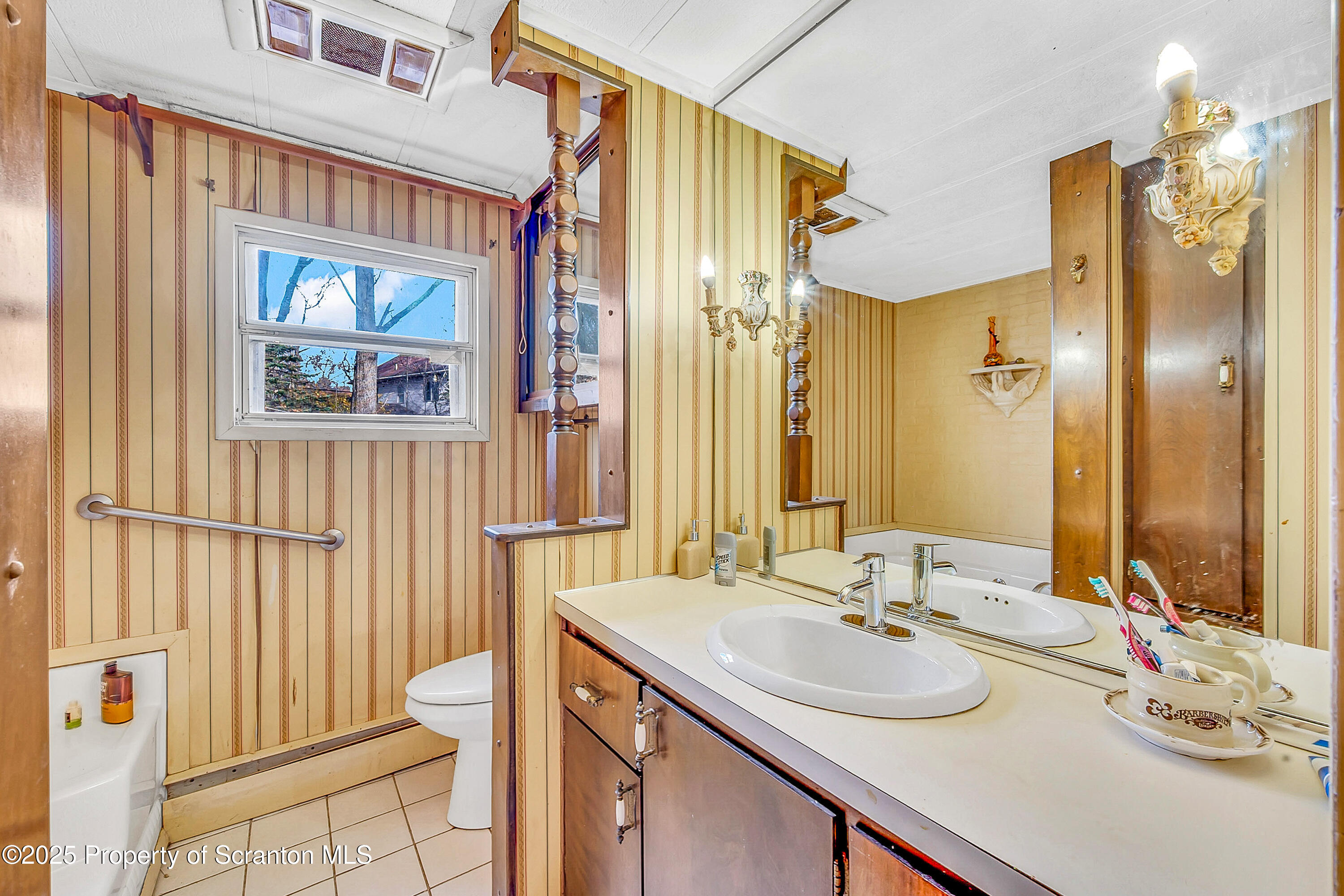 10 Bald Mt Road Clarks Summit, PA 18411 - Photo 22 of 42 a bathroom with a sink a toilet and a large mirror
