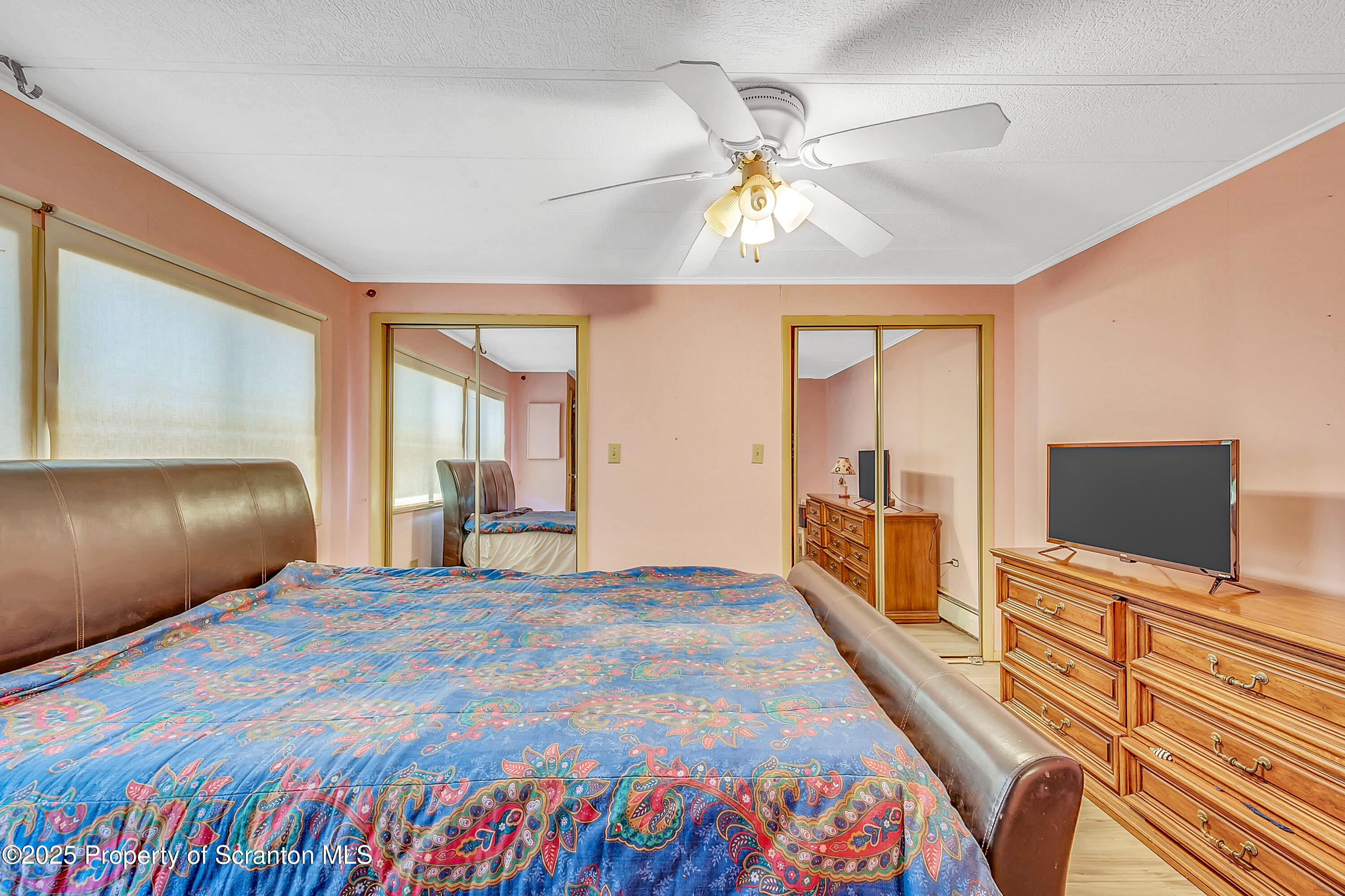 10 Bald Mt Road Clarks Summit, PA 18411 - Photo 25 of 42 a spacious bedroom with a bed and a flat tv screen on dresser