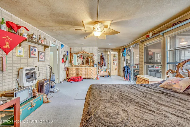 a bed room with a bed and a chair