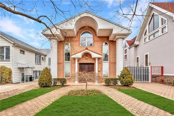 a front view of a house with a yard