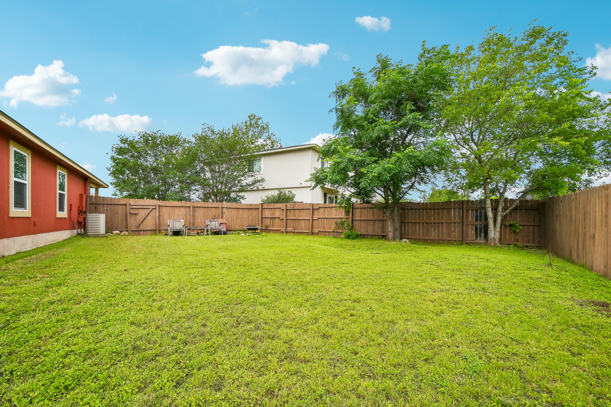 125 Mason Reed Cove Kyle, TX 78640 - Photo 35 of 39 a view of a backyard with a garden