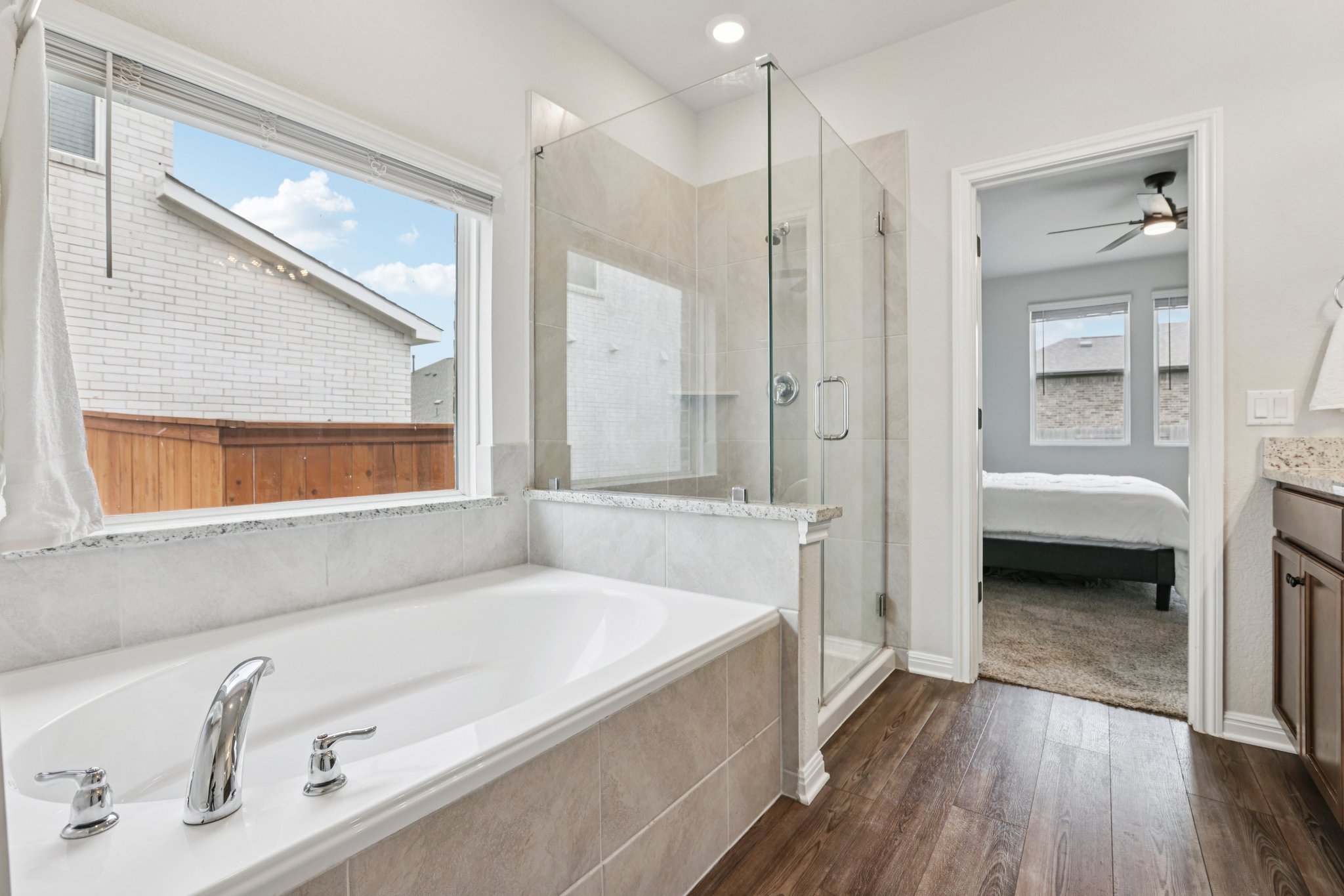 204 Swinging H Lane Georgetown, TX 78633 - Photo 16 of 39 a bathroom with a tub a sink and a large mirror