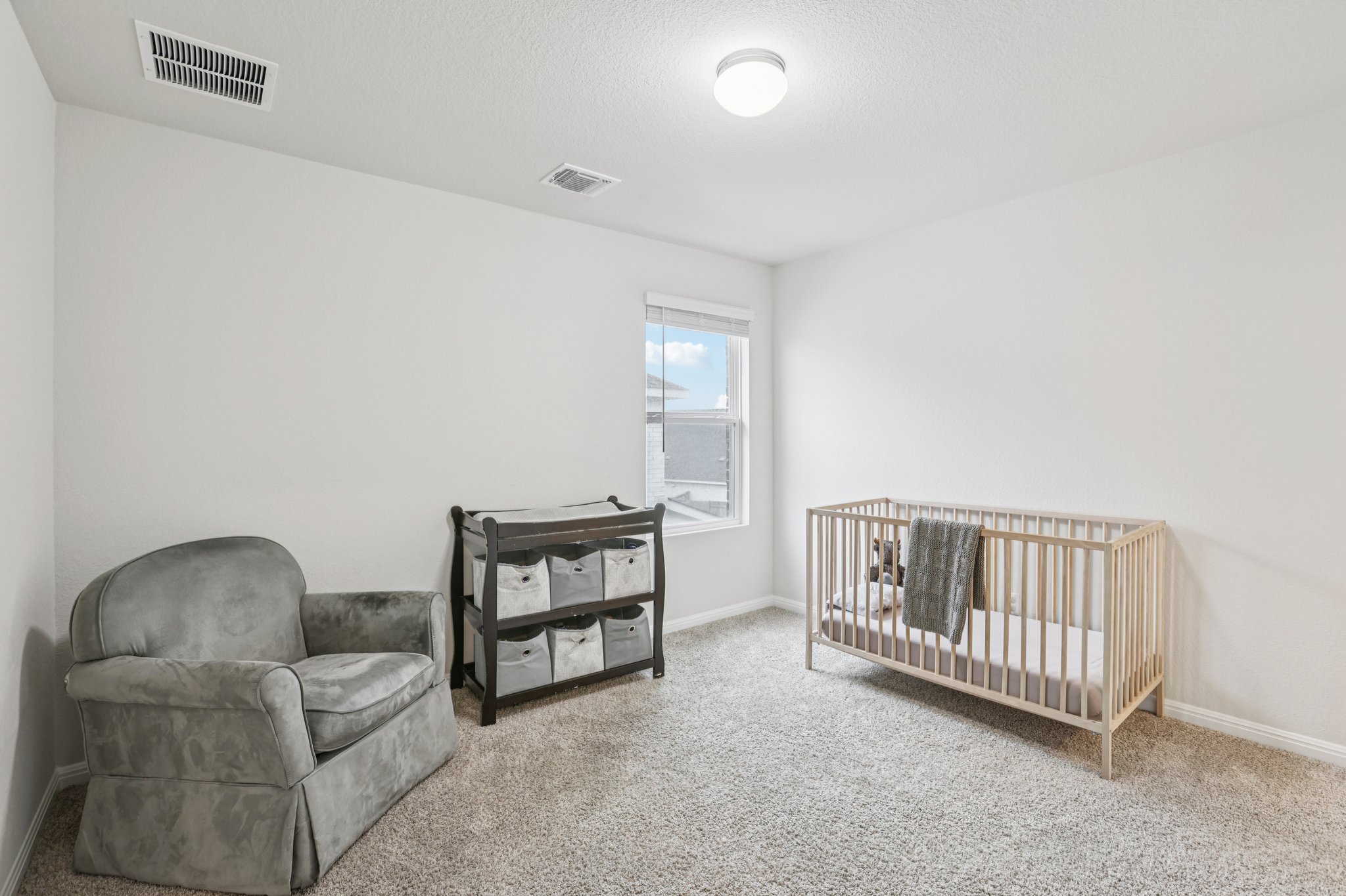 204 Swinging H Lane Georgetown, TX 78633 - Photo 24 of 39 a living room with furniture and a baby crib
