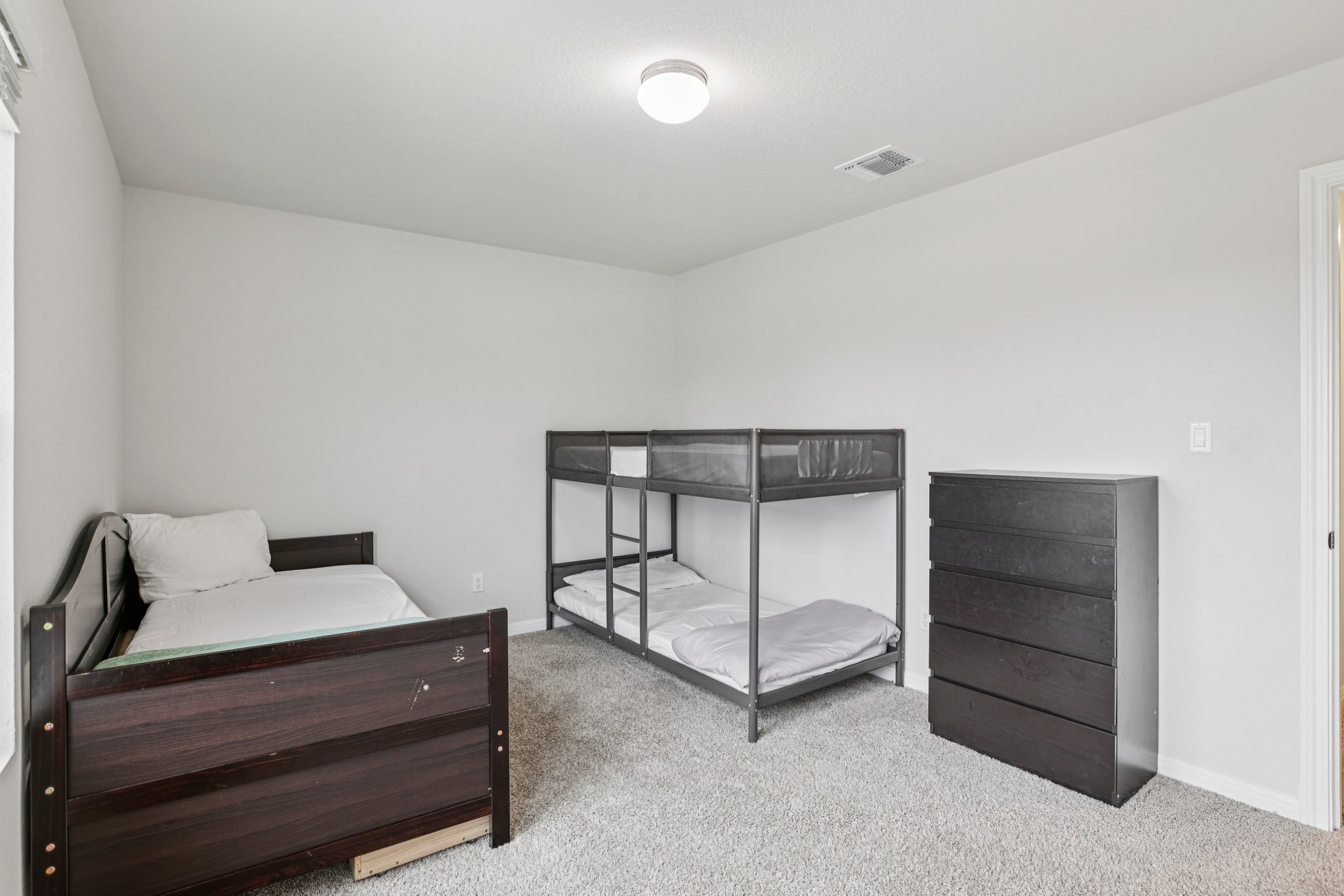 204 Swinging H Lane Georgetown, TX 78633 - Photo 29 of 39 This room features light gray walls, a light gray carpet, and a ceiling light fixture