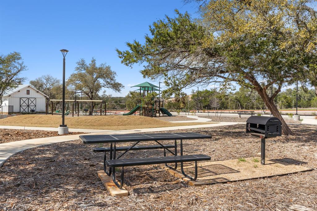 204 Swinging H Lane Georgetown, TX 78633 - Photo 36 of 39 This outdoor area features a picnic table, a barbecue grill, and a paved pathway