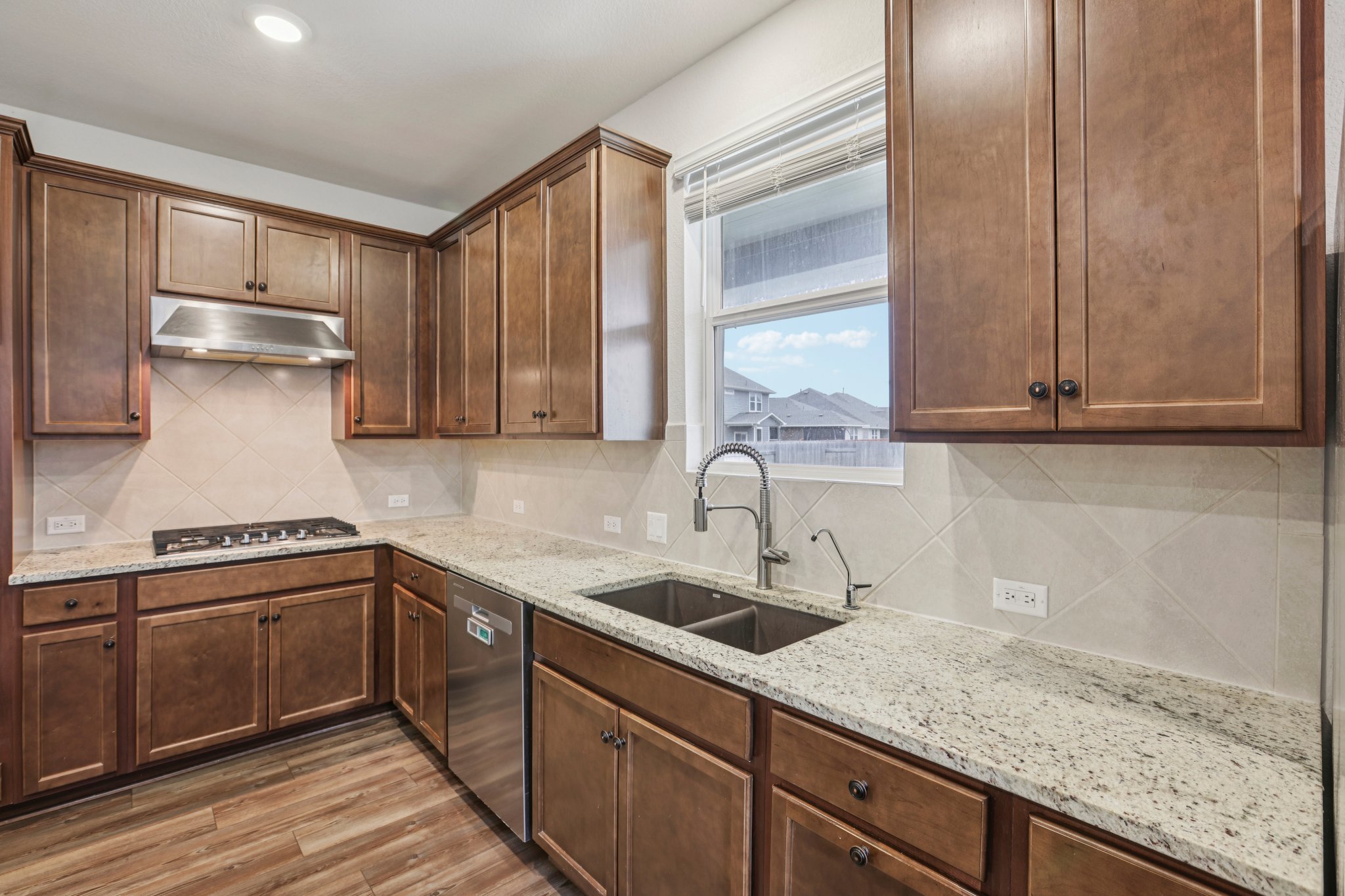 204 Swinging H Lane Georgetown, TX 78633 - Photo 8 of 39 a kitchen with a sink and cabinets
