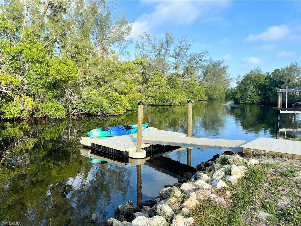 a view of a lake with couches and wooden floor