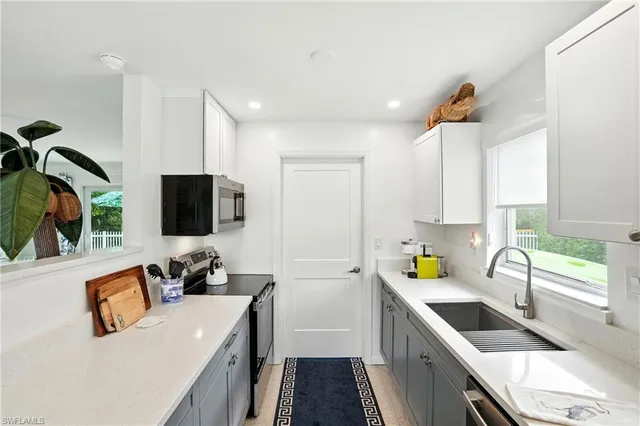 a kitchen that has a sink and a stove in it
