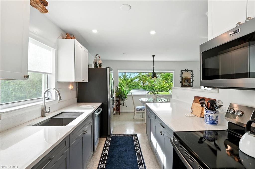 578 14th Street North Naples, FL 34102 - Photo 12 of 28 a kitchen with a sink stove top oven and refrigerator