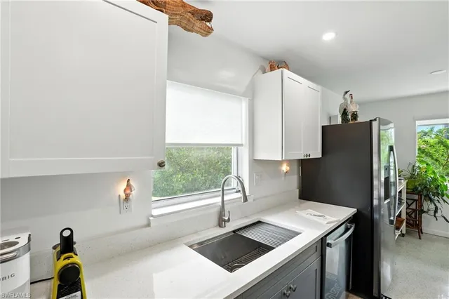 a kitchen with a sink and a refrigerator