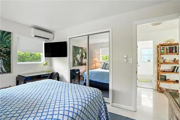 a bedroom with a bed and a flat screen tv
