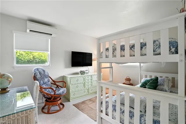 a view of a livingroom with wooden floor and windows