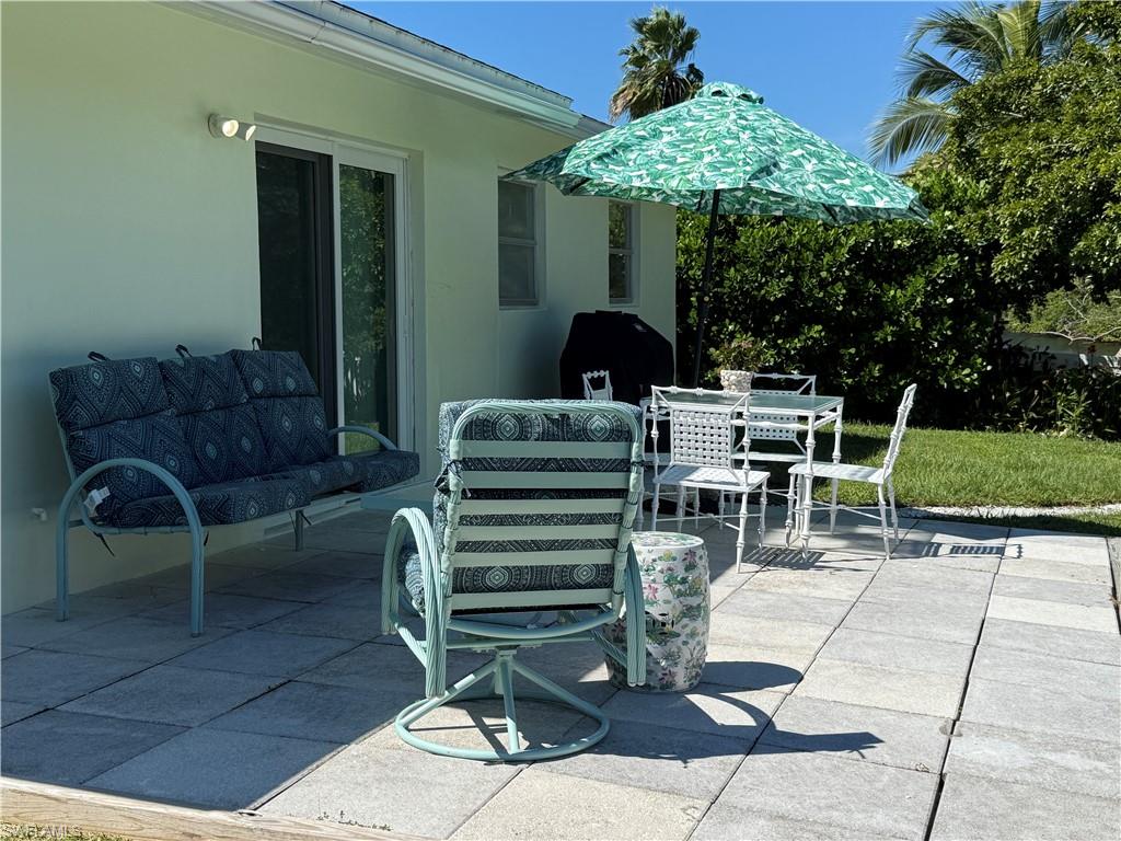 578 14th Street North Naples, FL 34102 - Photo 24 of 28 a view of a chairs and tables in the patio