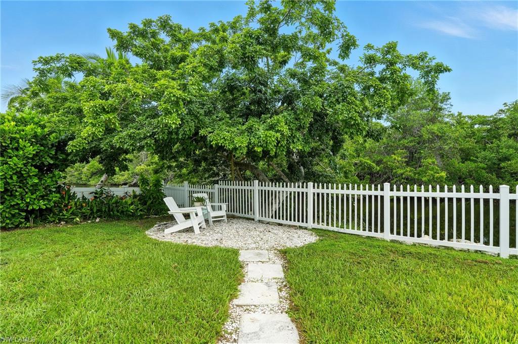 578 14th Street North Naples, FL 34102 - Photo 25 of 28 a view of a chair and table in the garden