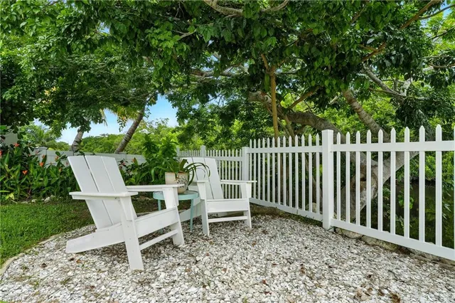 a white bench sitting in backyard of a house