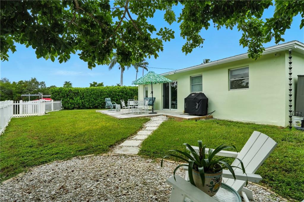 578 14th Street North Naples, FL 34102 - Photo 27 of 28 a view of a chair and table in the garden
