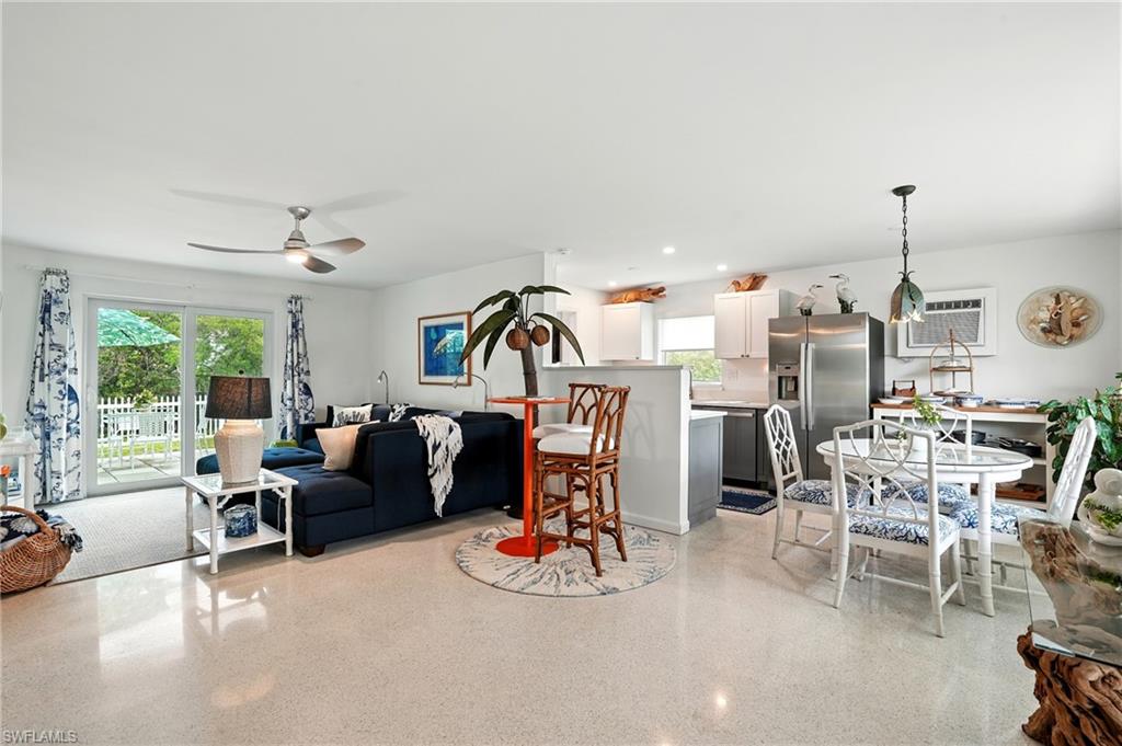 578 14th Street North Naples, FL 34102 - Photo 3 of 28 a living room with furniture and a chandelier