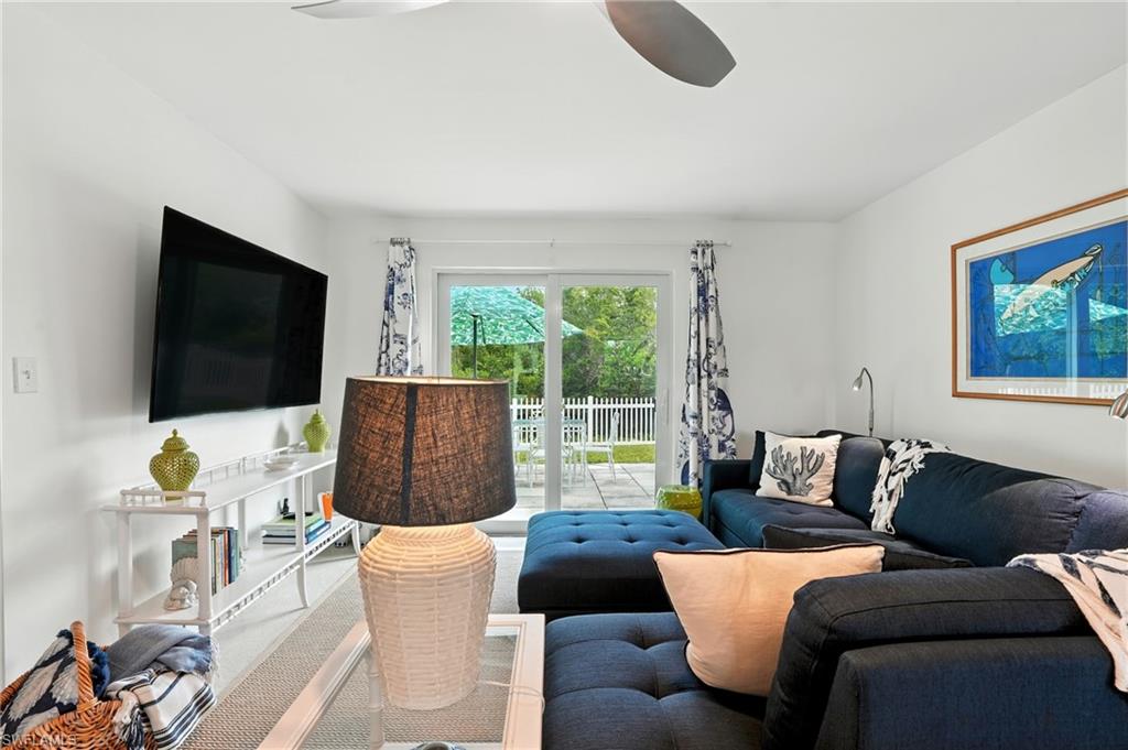 578 14th Street North Naples, FL 34102 - Photo 6 of 28 a living room with furniture and a flat screen tv